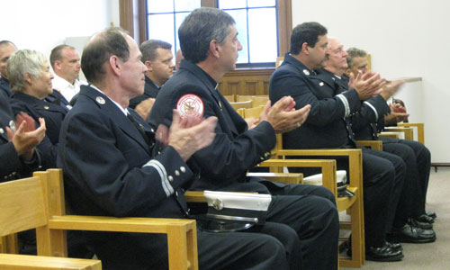 Firefighters applaud their own during the presentation of service awards.