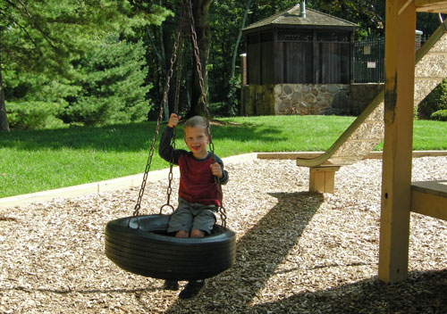 St. Matthew Parish member Teddy Marous gets ready for the picnic by testing out the swingers at the Laborers