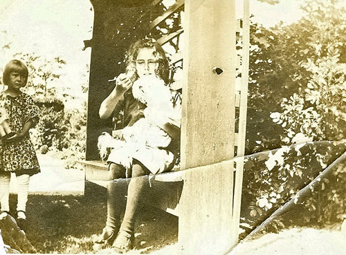 Dog and two girls in Kidder sunken garden arbor