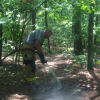 Firefighter dousing small fire embers at Breakneck Hill