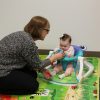 NECC's Dr. Rebecca McDonald, PhD, BCBA, Senior Program Manager and lead on the Infant Sibling Research Project, assesses an infant for autism  (contributed)