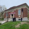 hanging ARHS congrats banner at Library (SFD Facebook)