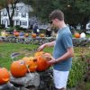 pumpkins are displayed on the stone wall with lit candles inside for night time viewing (contributed by Rotary)