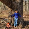 Southborough resident April Gibson demonstrates the size of the Constitution Ash