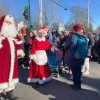 Mr and Mrs Claus head into the Community House - passing families waiting to see them at 2024 Santa Day (photo by Beth Melo)